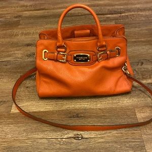 i am selling a burnt orange used Michael Kors Bag.